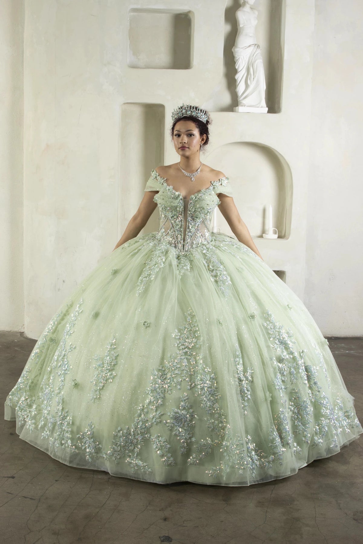 Sage quinceañera ball gown with illusion corset bodice, floral applique, beaded embroidery and flowing skirt