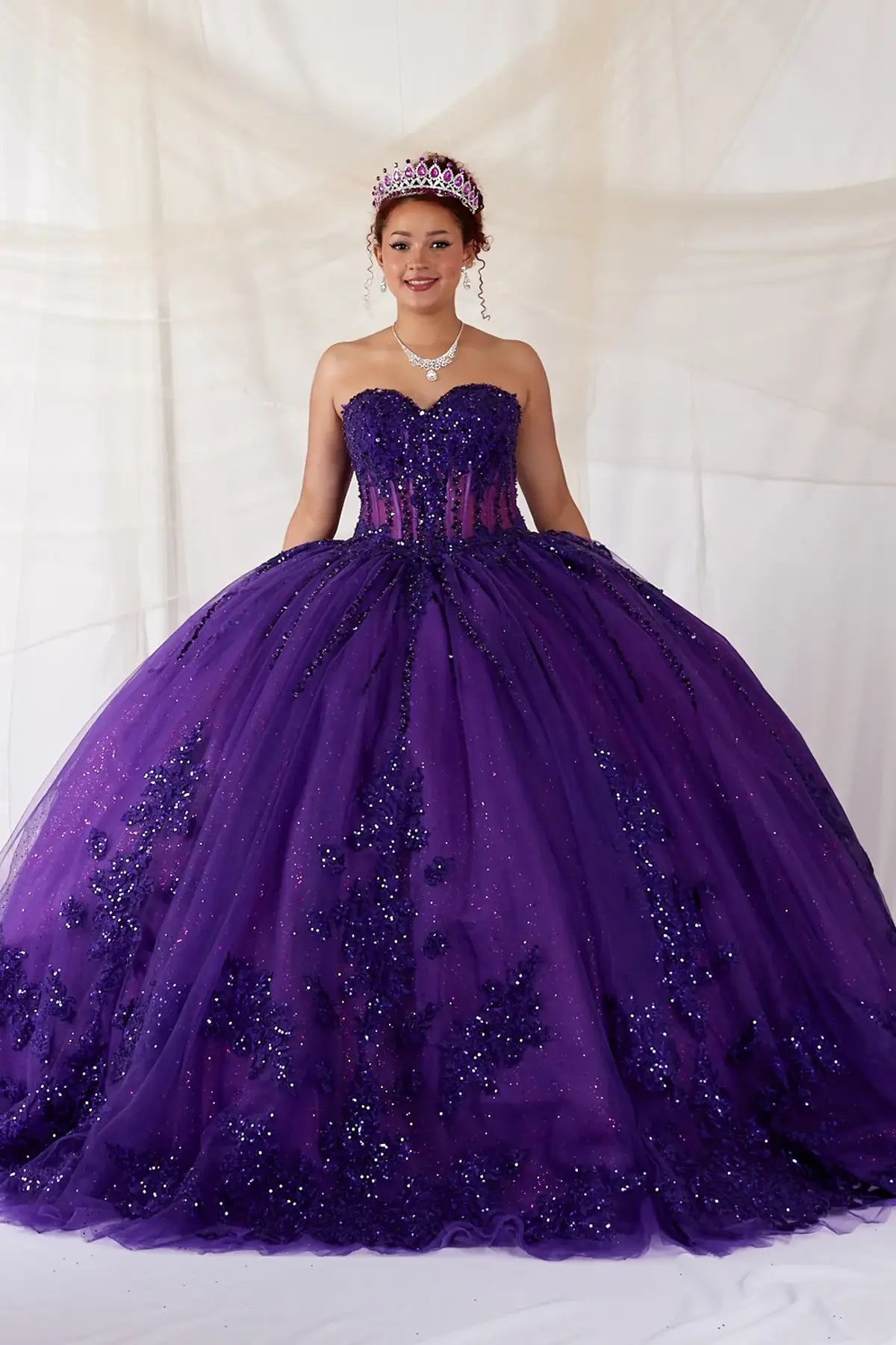 Purple quinceañera ball gown with strapless bodice, lace applique, shimmer beading and glitter tulle skirt