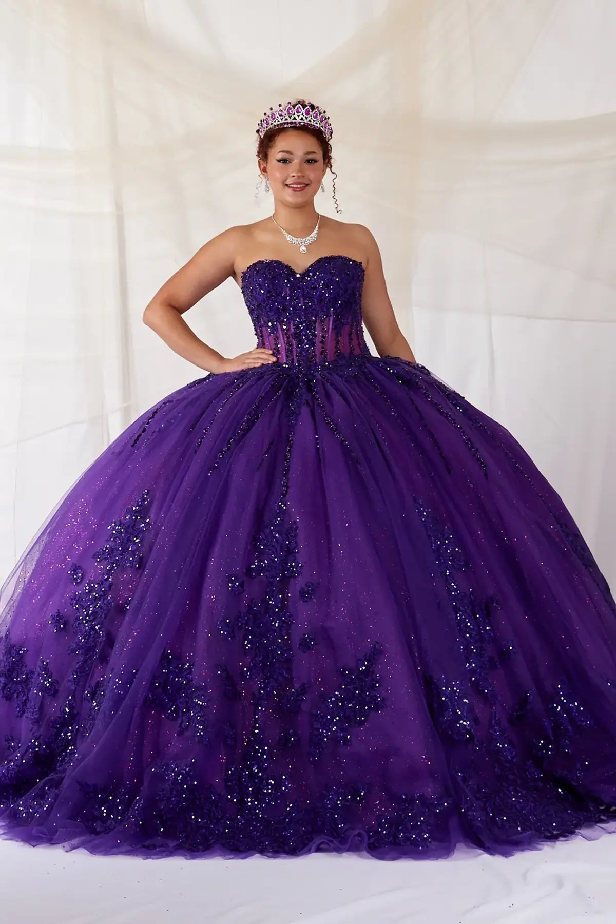 Purple quinceañera ball gown with strapless bodice, lace applique, shimmer beading and embroidered tulle skirt