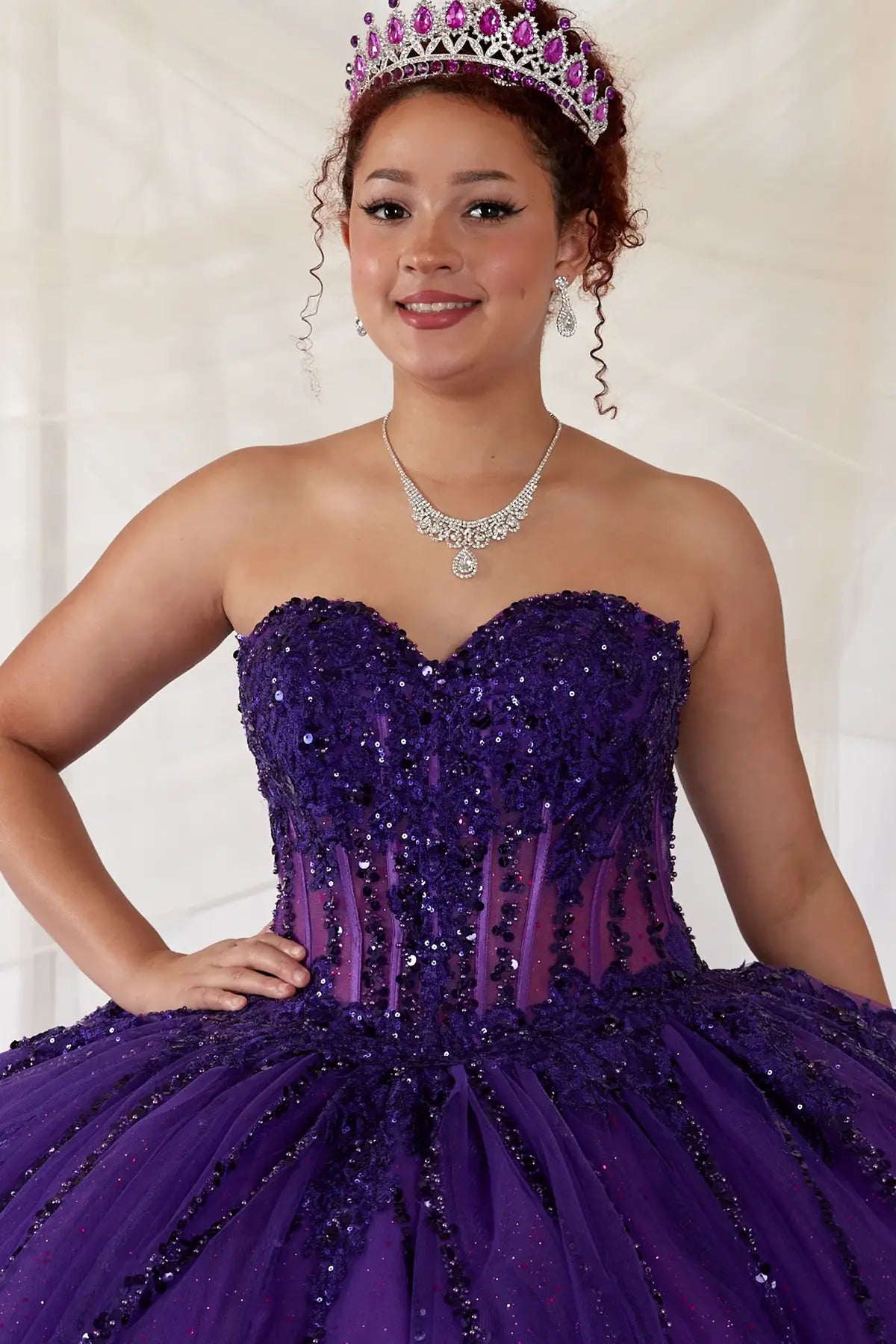 Purple quinceañera ball gown with strapless bodice, lace applique, shimmer beading and embroidered tulle skirt