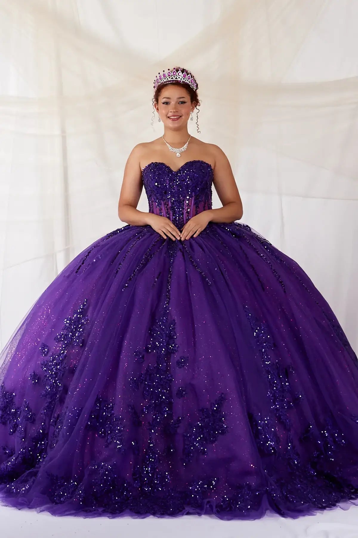 Purple quinceañera ball gown with strapless bodice, lace applique, shimmer beading and embroidered tulle skirt