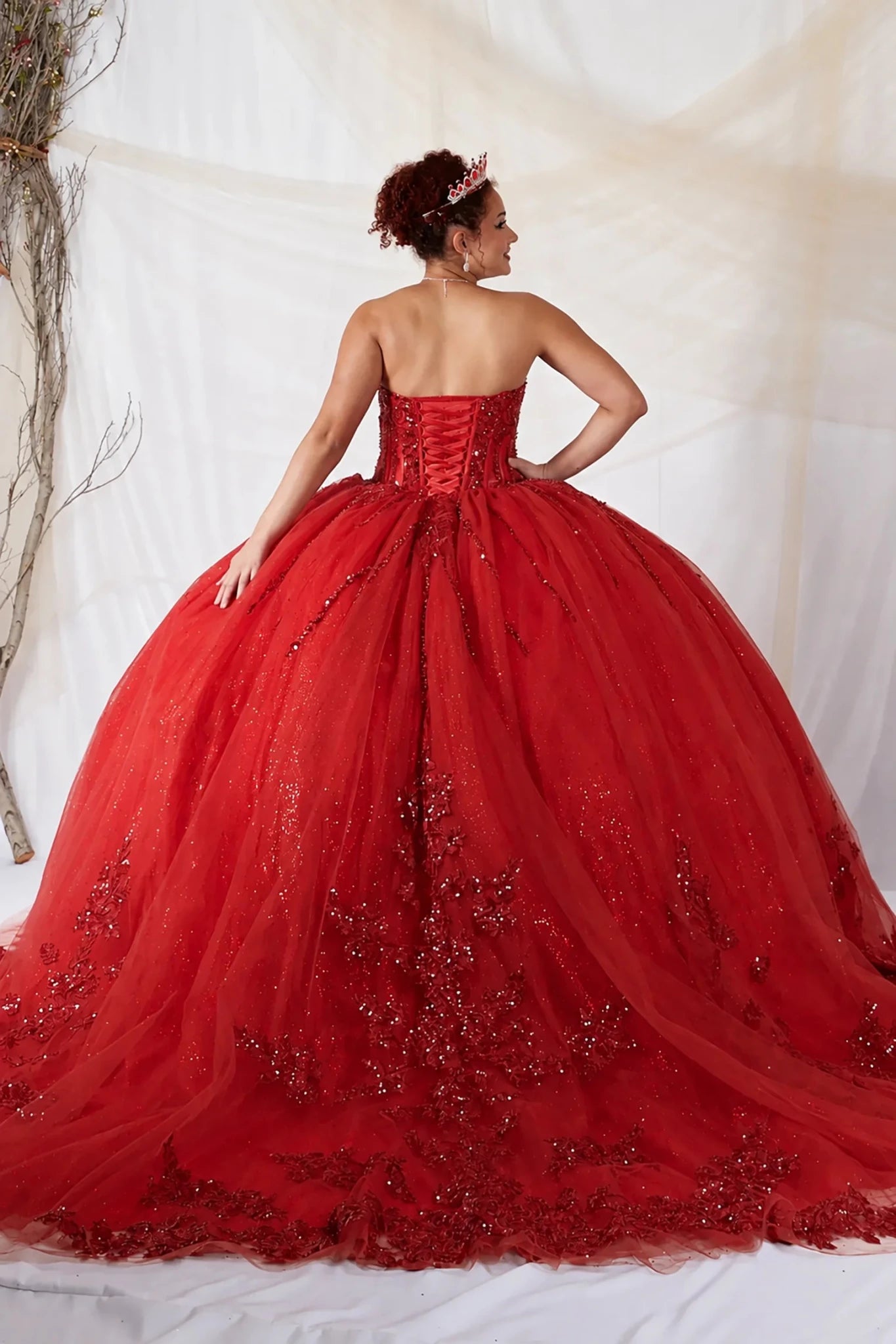 Red quinceañera ball gown with strapless bodice, lace applique, shimmer beading and glitter tulle skirt