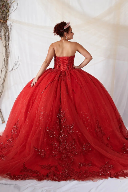 Detailed view highlights red quinceañera ball gown with strapless bodice, lace applique, shimmer beading and glitter tulle skirt.