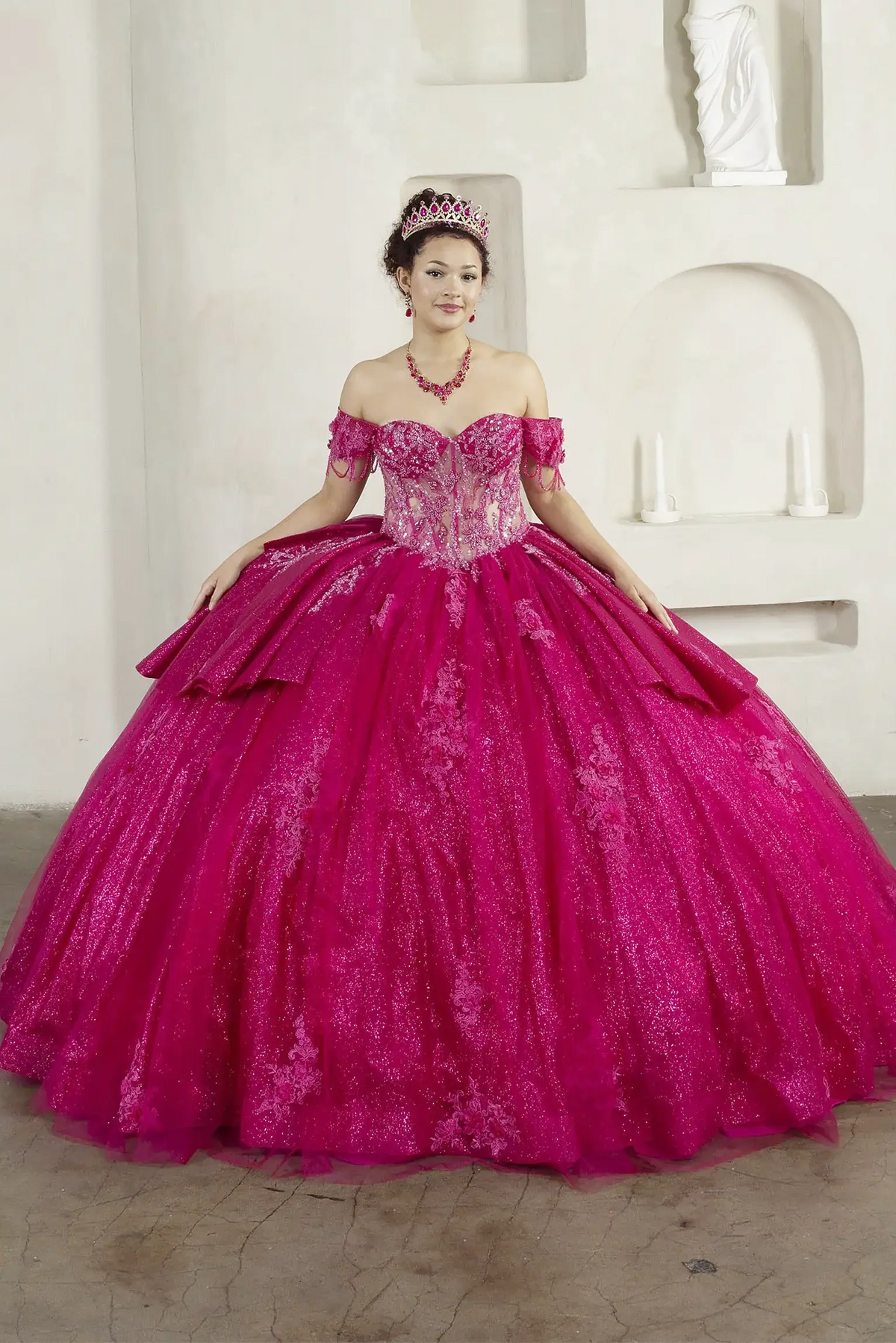 Fuchsia quinceañera ball gown with beaded fringe straps, embroidered lace and ruffled train