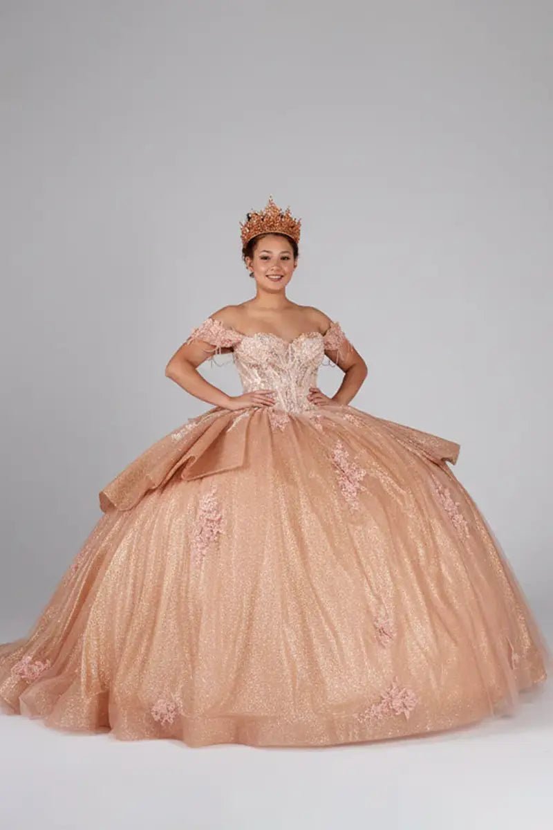 Rose gold quinceañera ball gown with beaded fringe straps, embroidered lace and ruffled train
