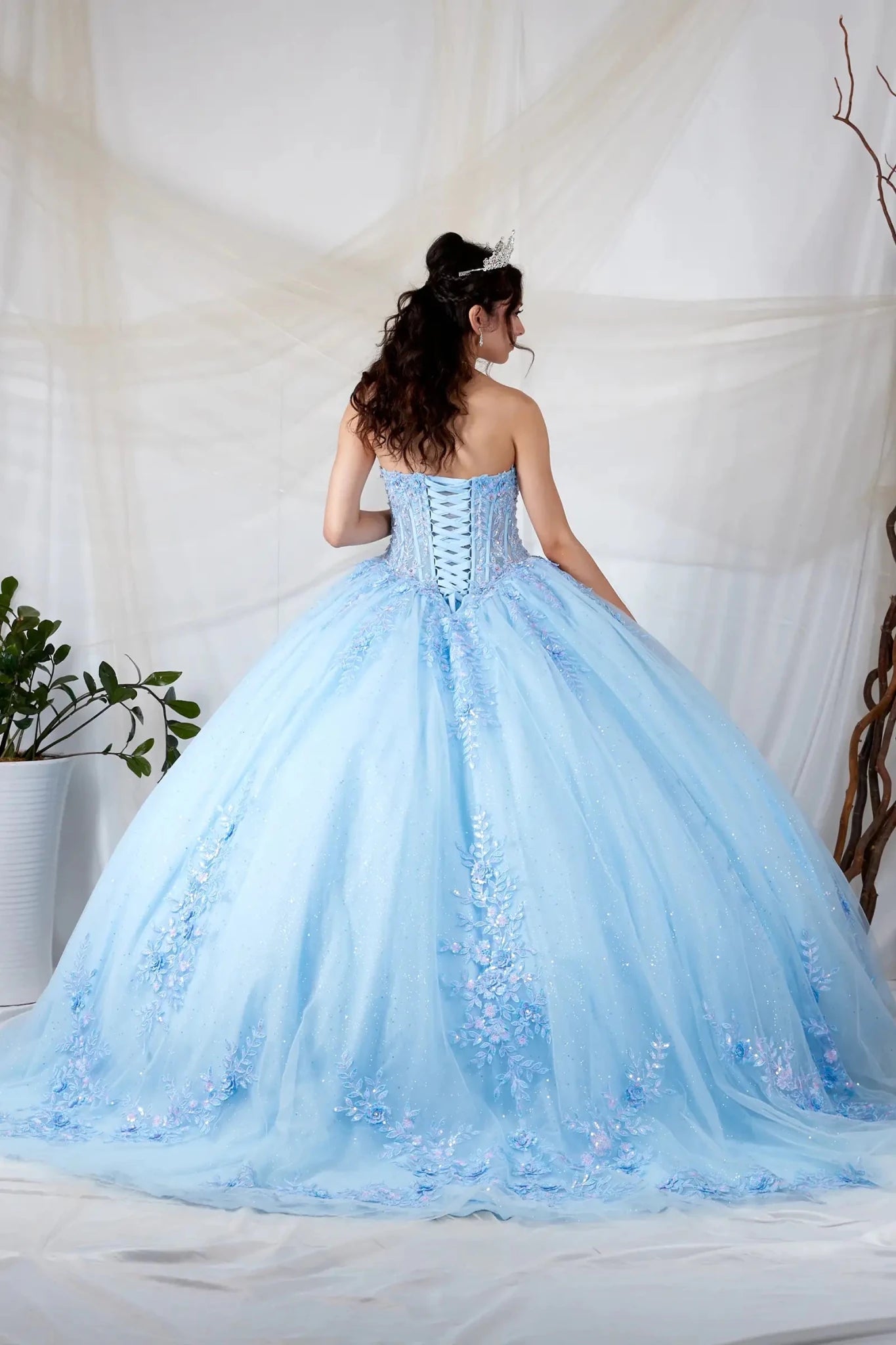 Light blue quinceañera ball gown with beaded bodice, floral applique and glitter tulle skirt