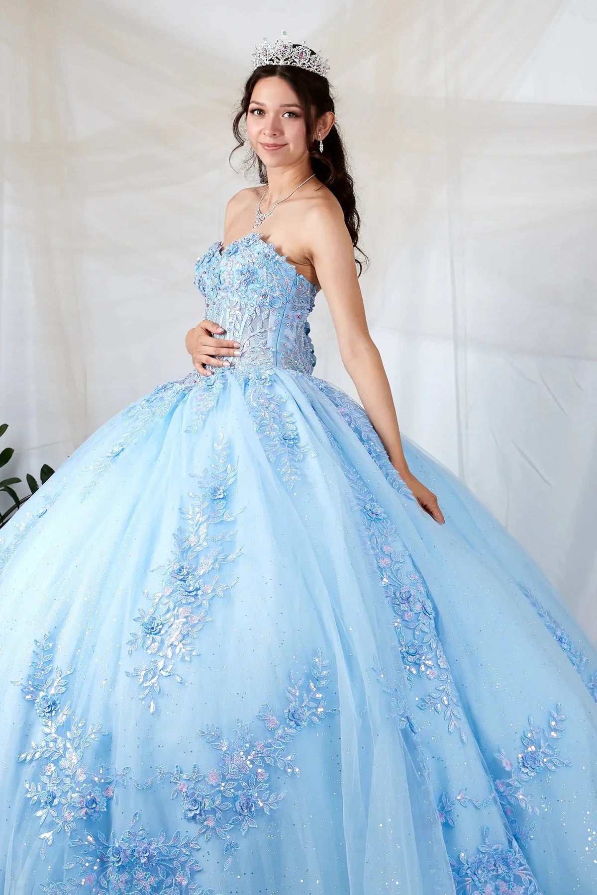 Light blue quinceañera ball gown with beaded bodice, floral applique and glitter tulle skirt