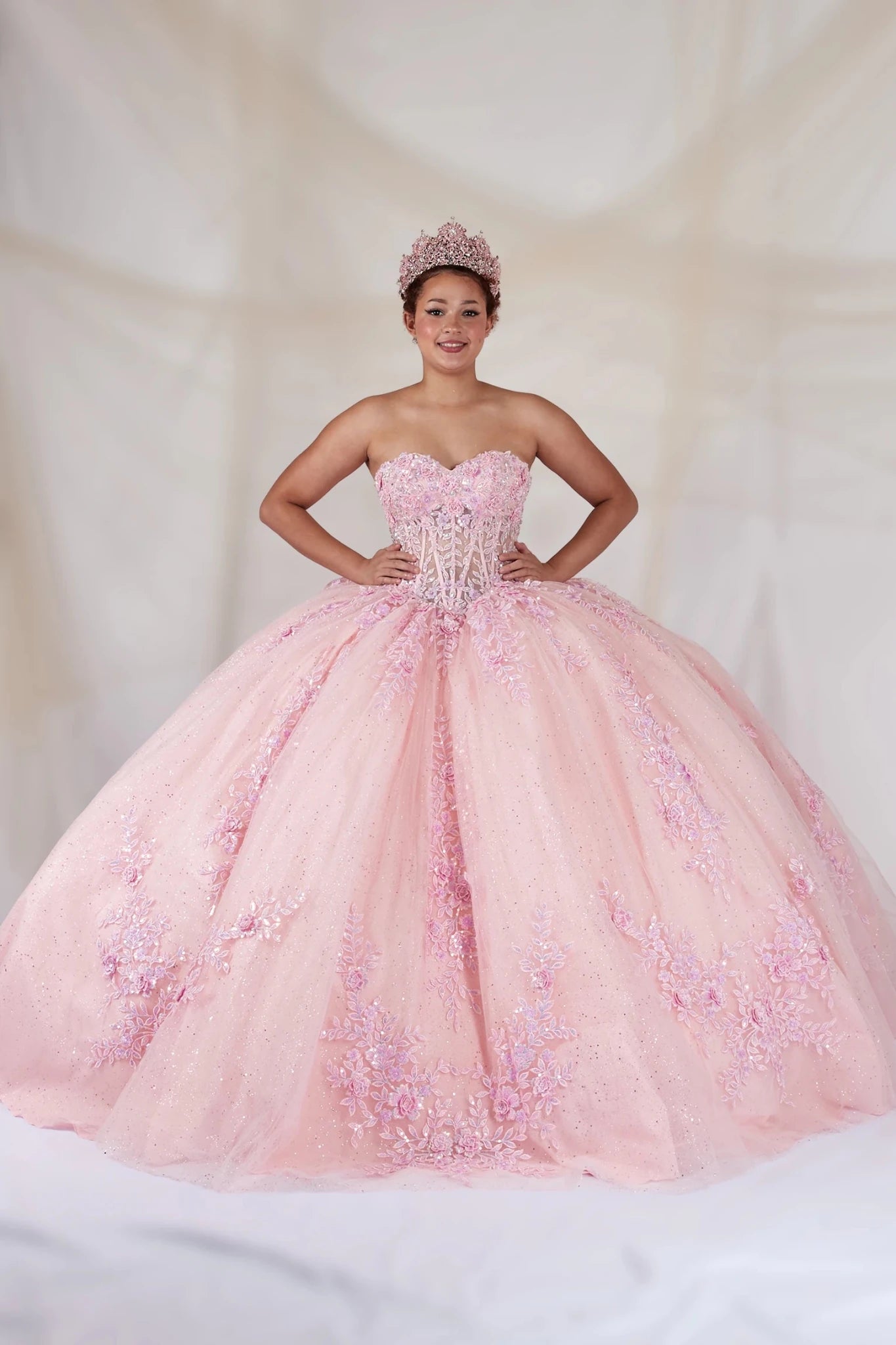 Pink quinceañera ball gown with strapless bodice, beaded embroidery, floral applique and glitter tulle skirt