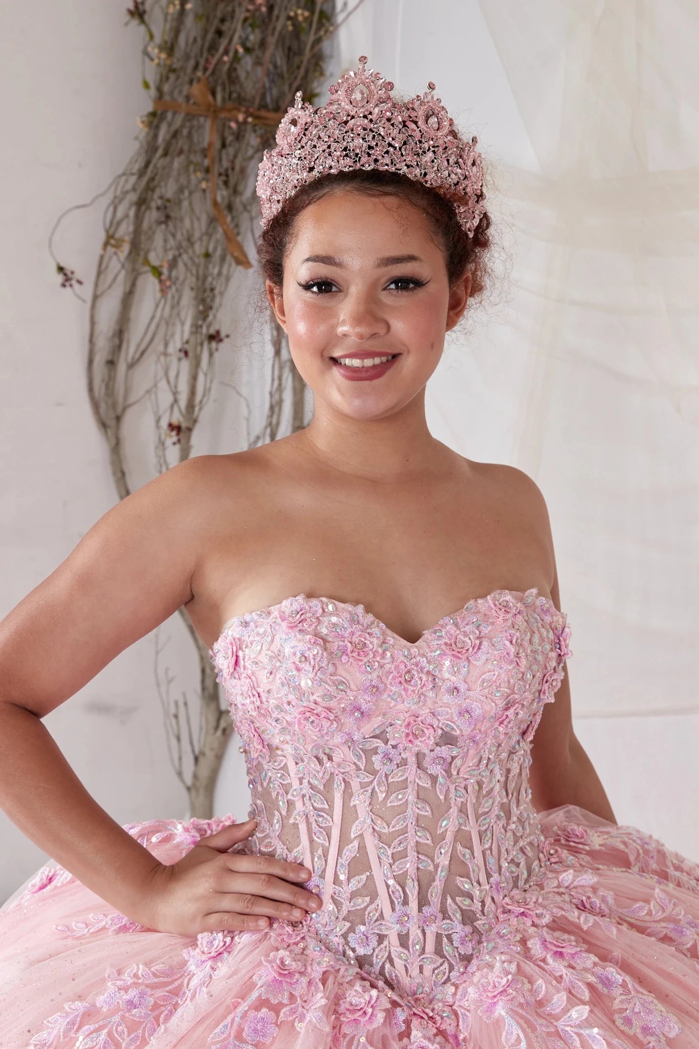 Blush quinceañera ball gown with sheer beaded bodice, rhinestone embroidery and glitter tulle skirt