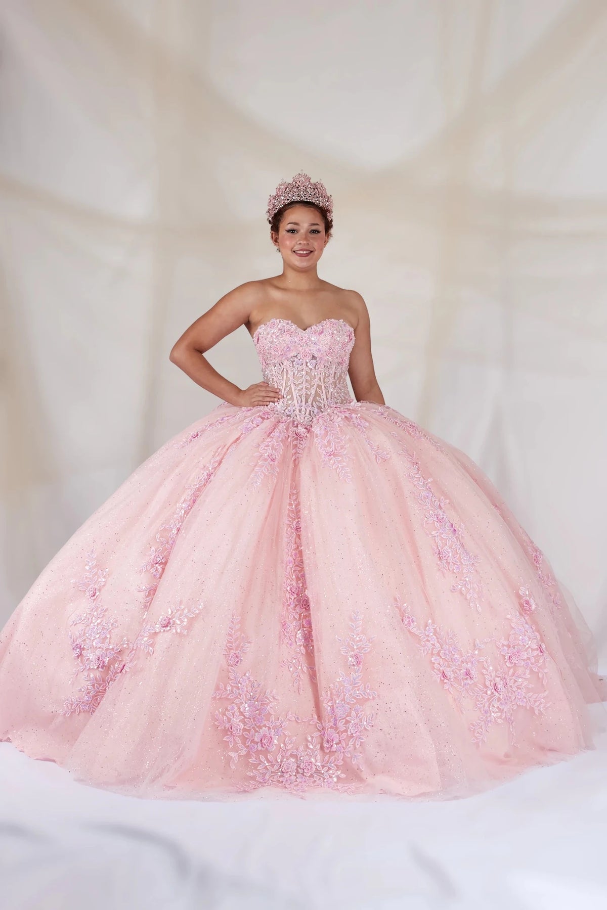 Pink quinceañera ball gown with strapless bodice, beaded embroidery, floral applique and glitter tulle skirt