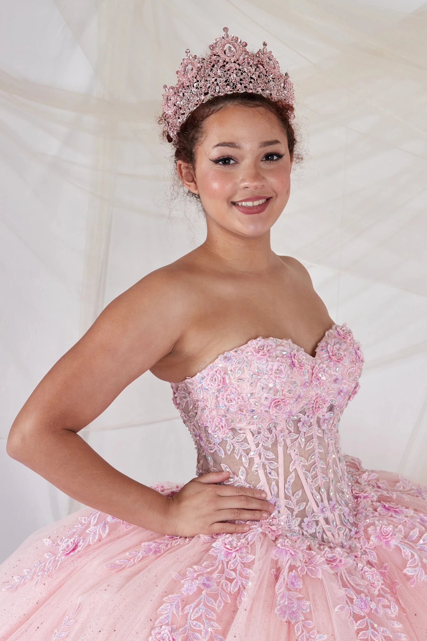 Pink quinceañera ball gown with strapless bodice, beaded embroidery, floral applique and glitter tulle skirt