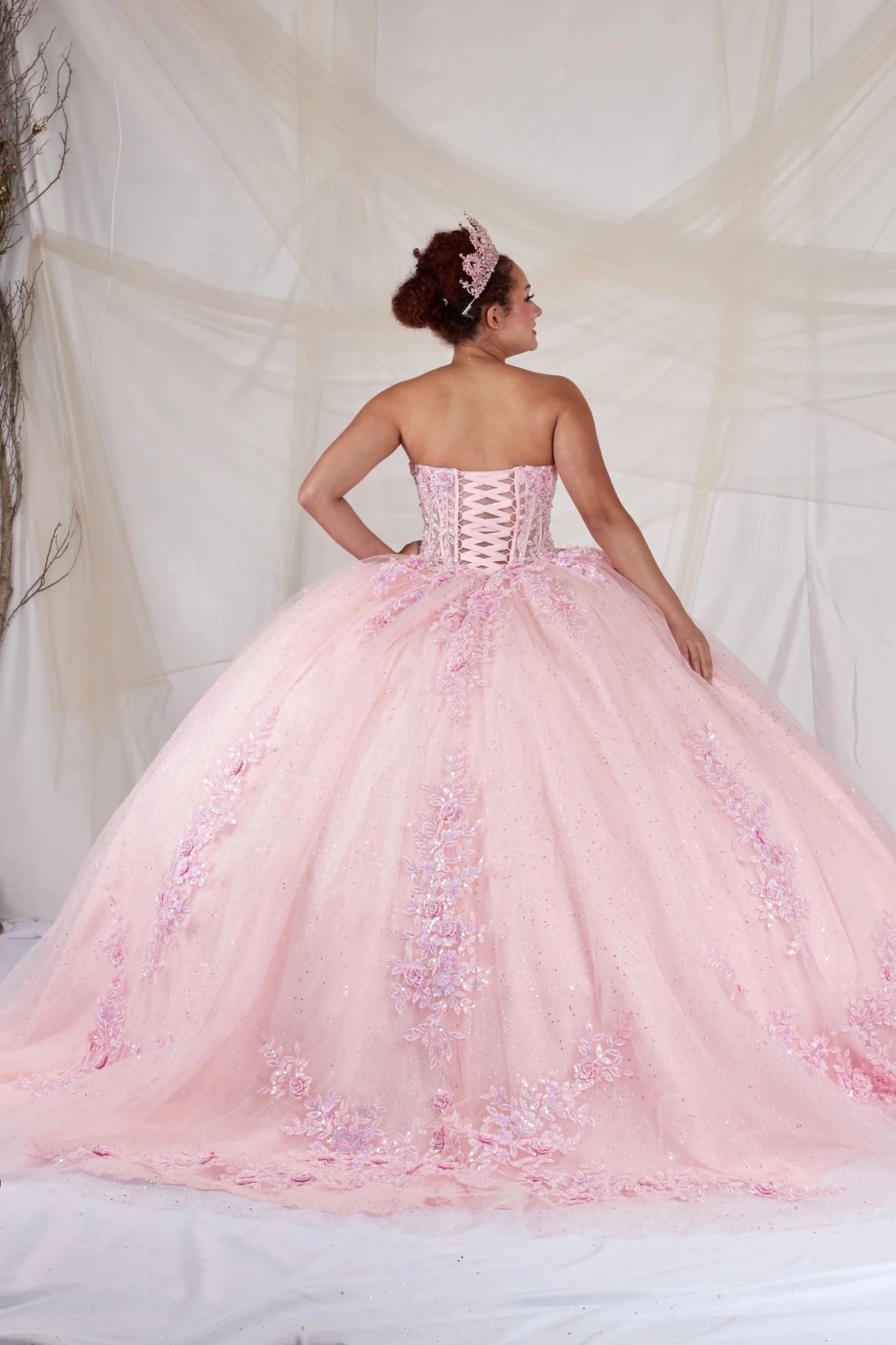 Pink quinceañera ball gown with strapless bodice, beaded embroidery, floral applique and glitter tulle skirt