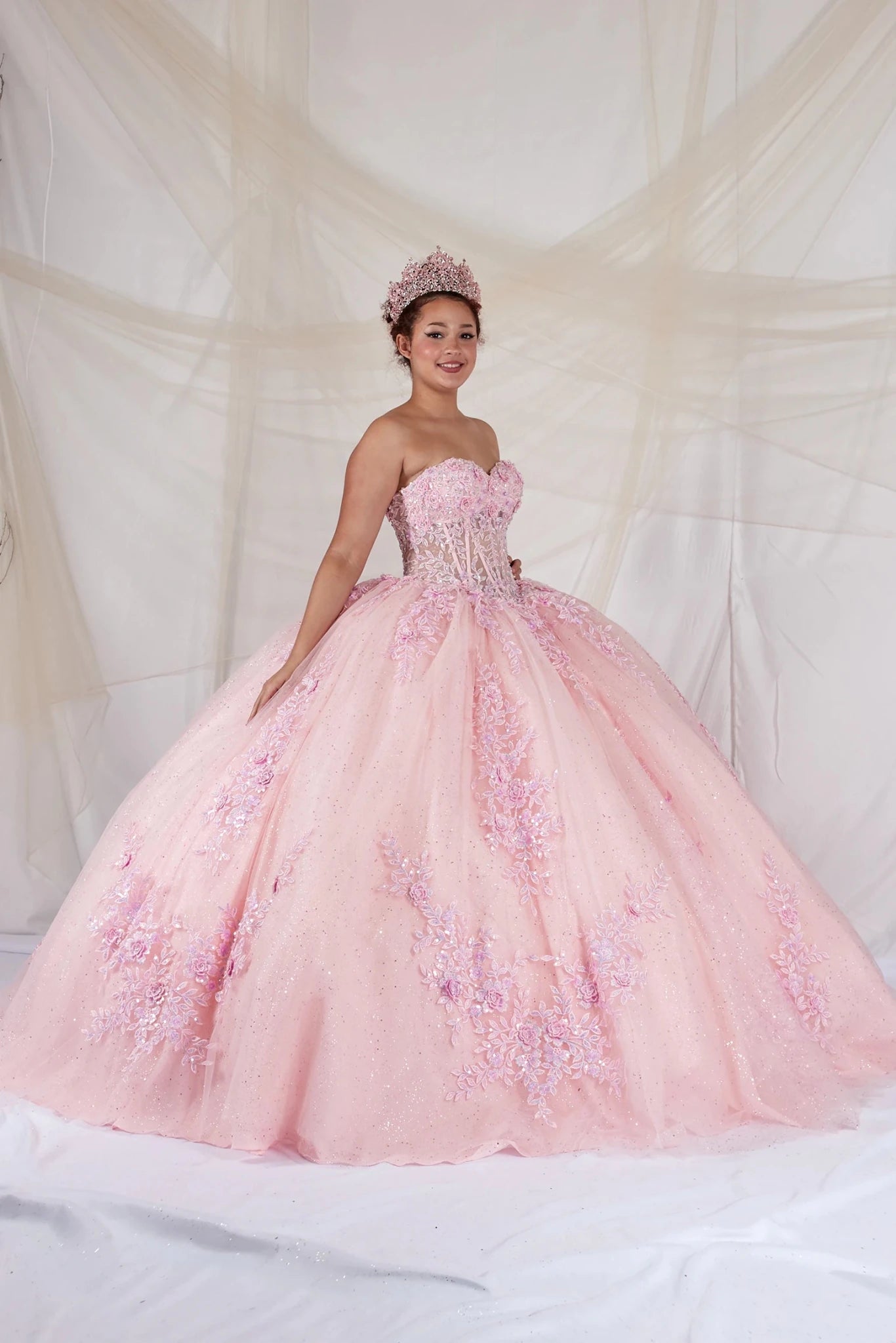 Pink quinceañera ball gown with strapless bodice, beaded embroidery, floral applique and glitter tulle skirt