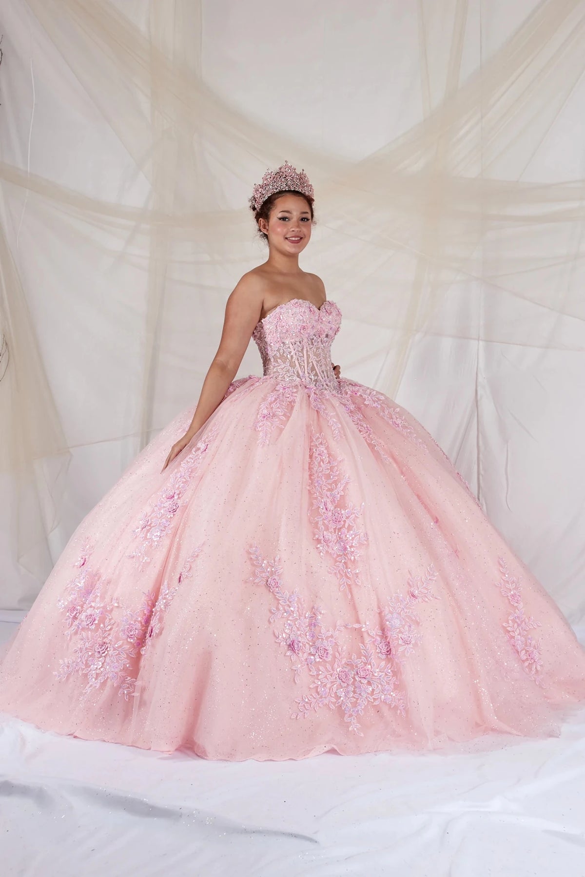 Pink quinceañera ball gown with strapless bodice, beaded embroidery, floral applique and glitter tulle skirt