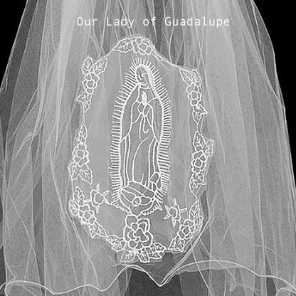applique with embroidered design of Our Lady of Guadalupe on a plain background