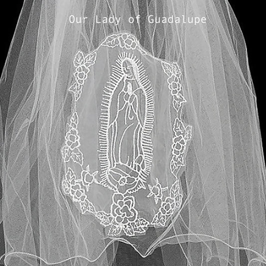 applique with embroidered design of Our Lady of Guadalupe on a plain background