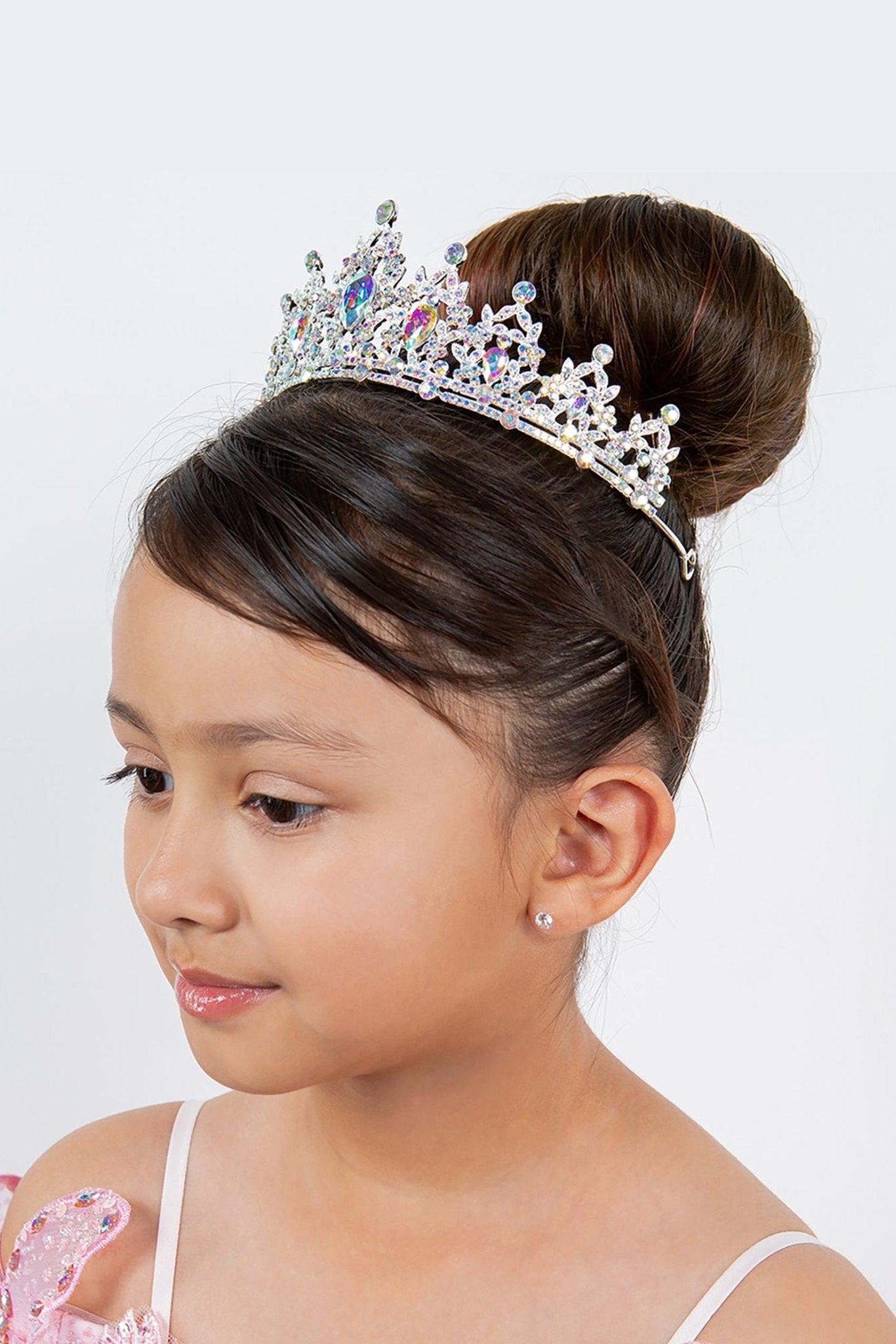 a kid wearing silver tiara with ab rhinestones