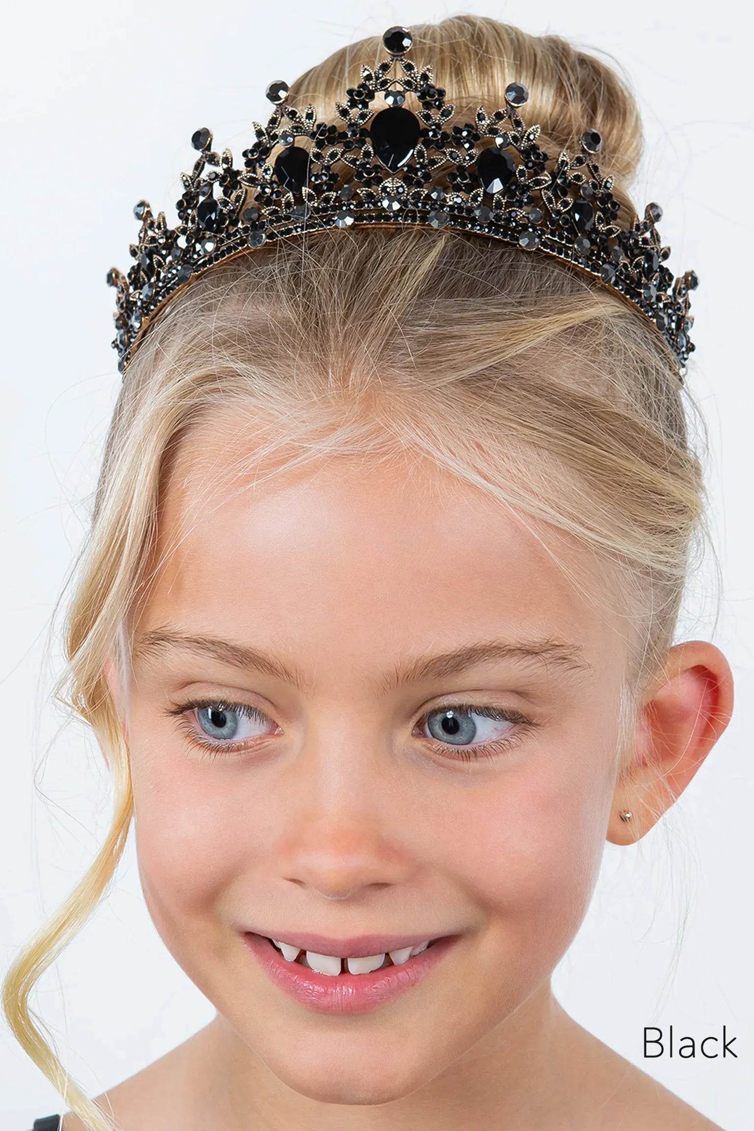 Young girl wearing a black tiara with black rhinestones