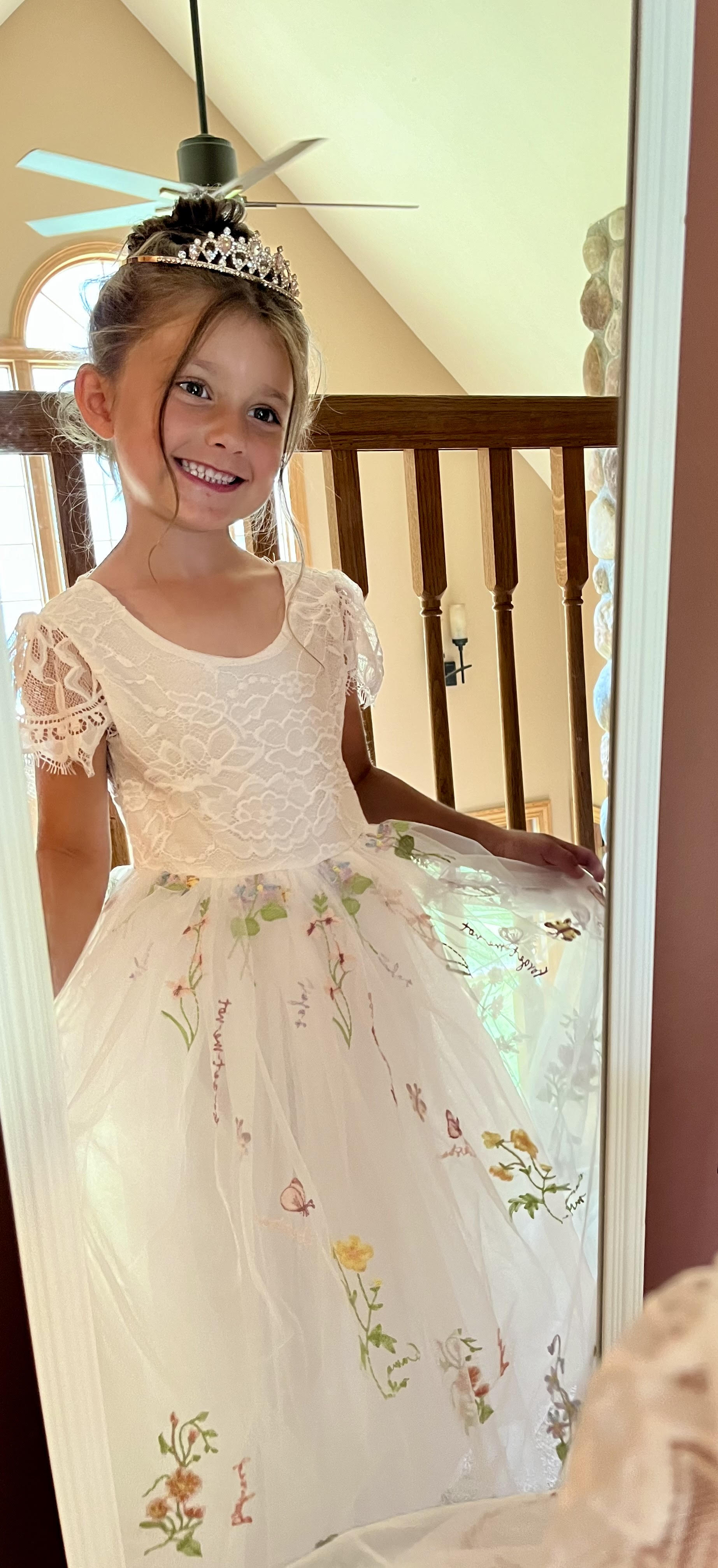 V-Back Soft Lace Top Embroidered Floral Tulle Cap Sleeves Dress | Flower Girl Dress | Special Occasion Dress – Hazel Dress front view through the mirror with a tiara