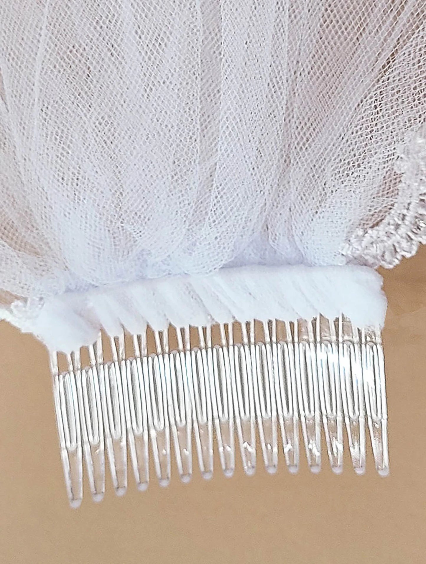 White rhinestone lace floral first communion veil, close-up, comb detail, embellishment detail.