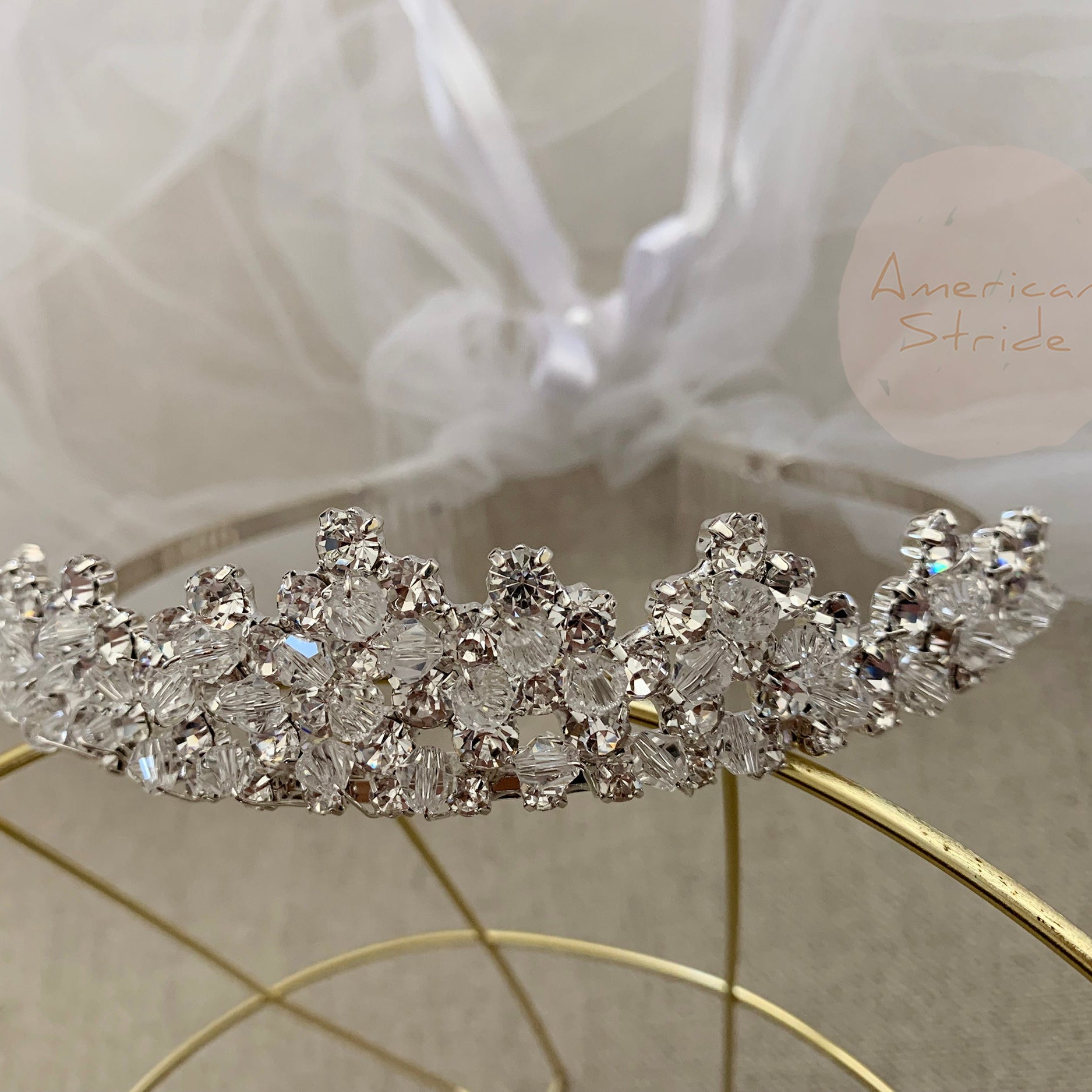 White rhinestone flower girl and first communion tiara and two-tier veil, close-up, embellishment detail.