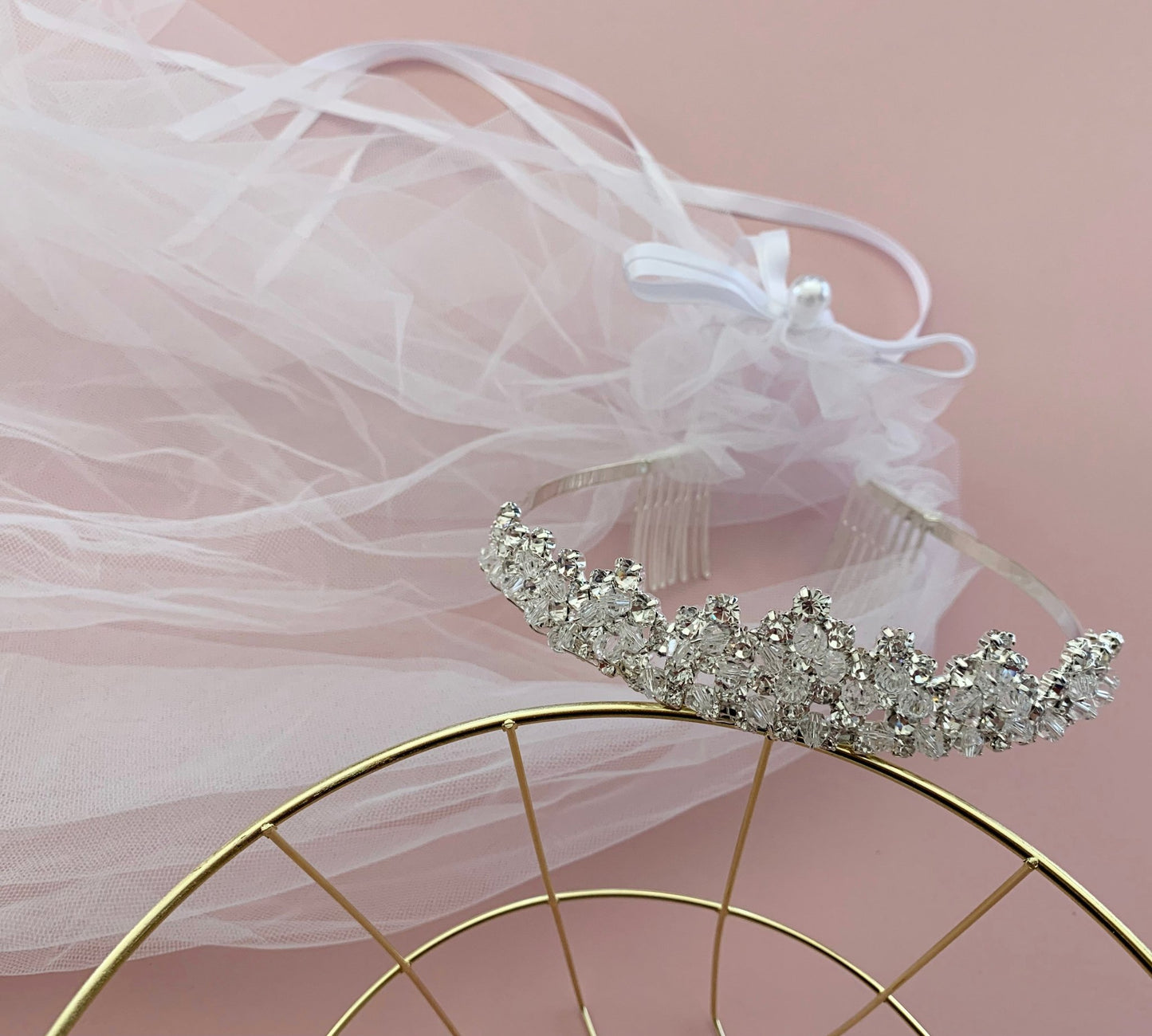 White rhinestone flower girl and first communion tiara and two-tier veil.