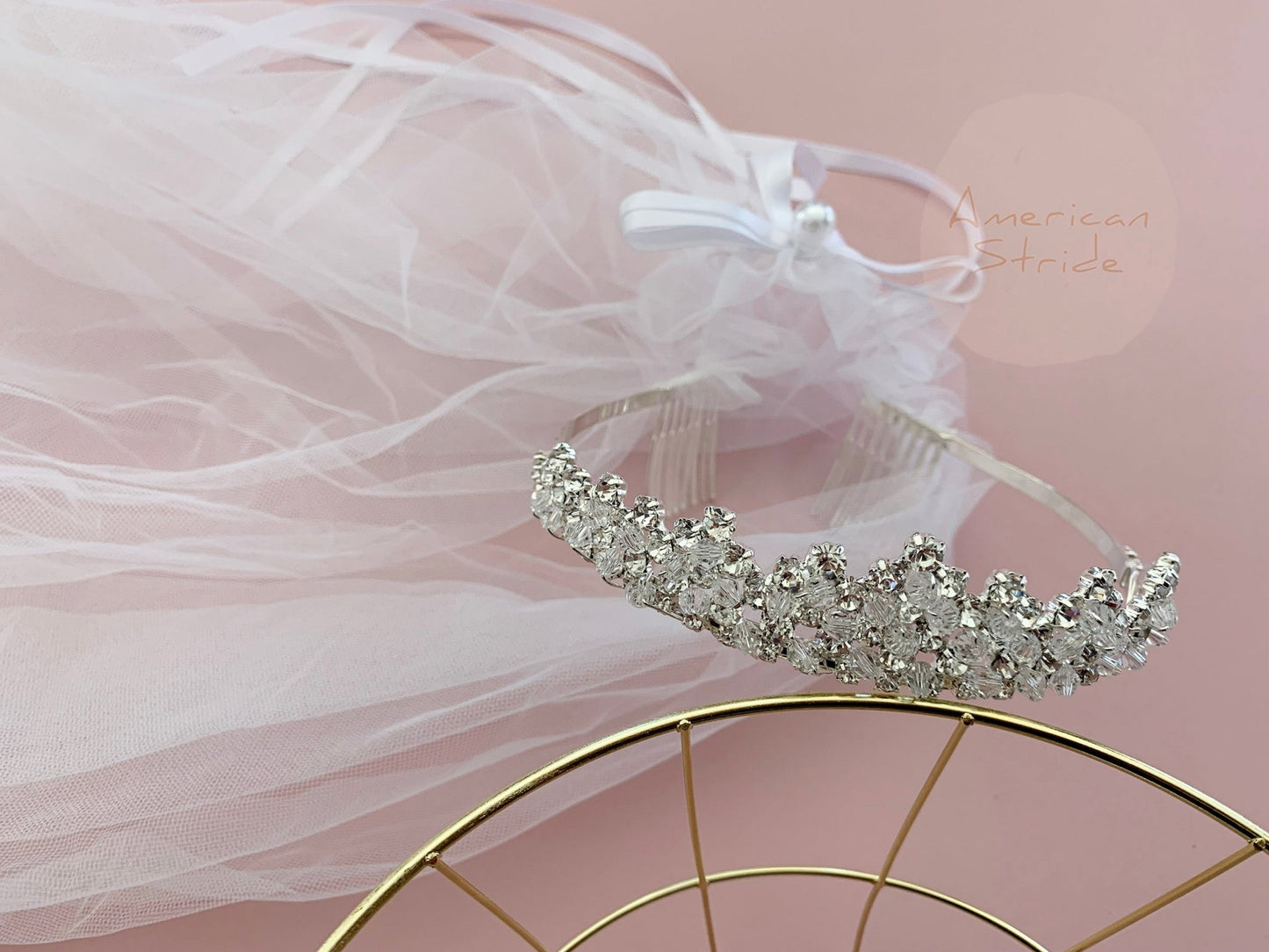 White rhinestone flower girl and first communion tiara and two-tier veil, close-up, embellishment detail.