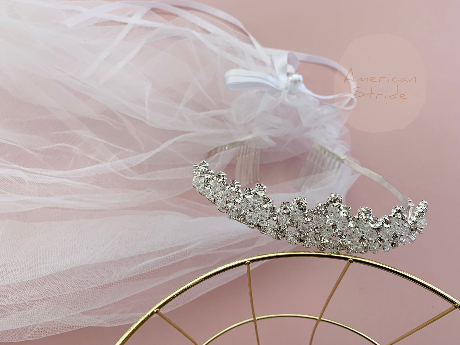 White rhinestone flower girl and first communion tiara and two-tier veil, close-up, embellishment detail.