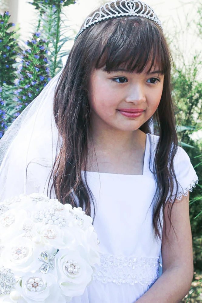 White rhinestone floral cross first communion tiara and two-tier veil.
