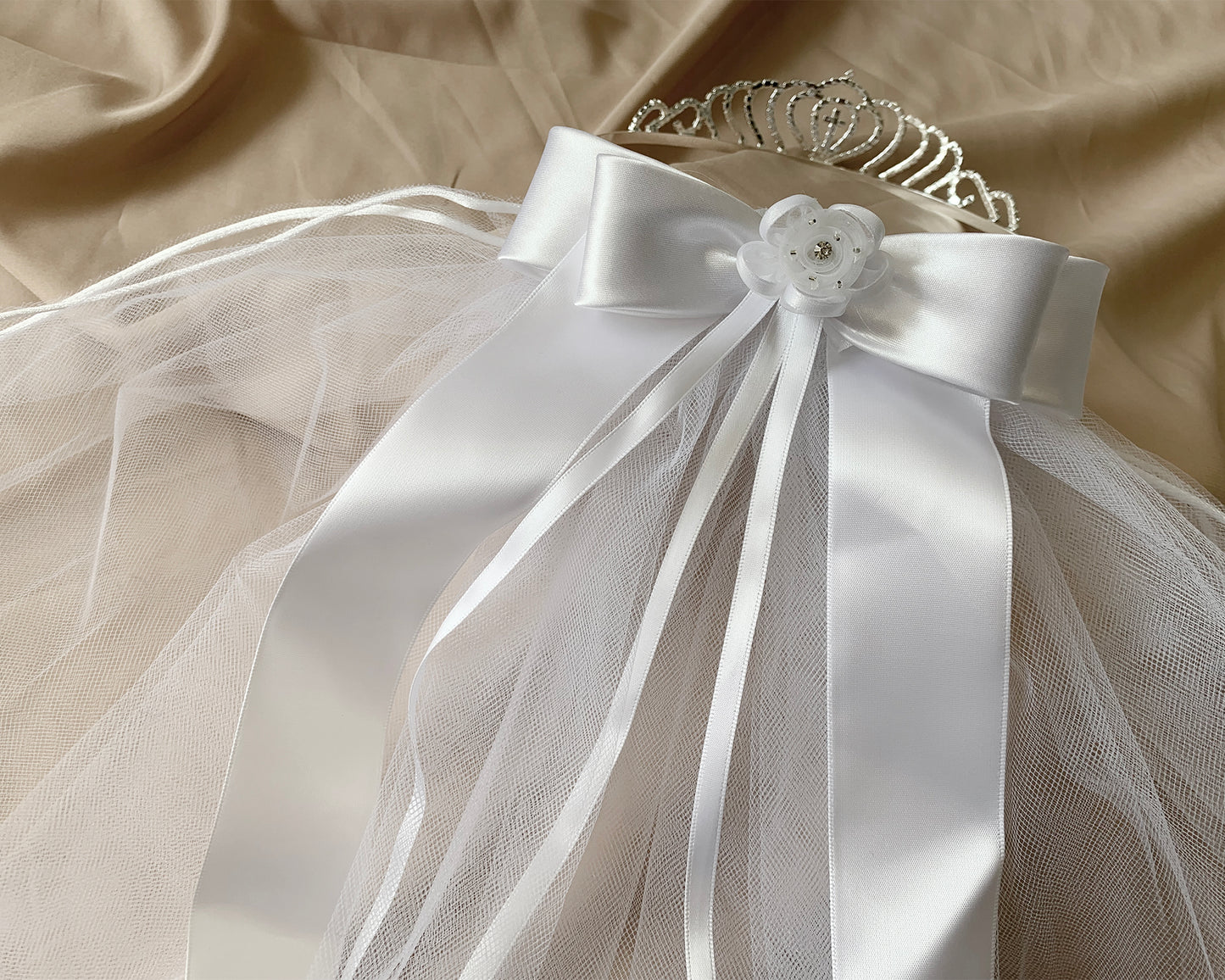 White rhinestone floral cross first communion tiara and two-tier veil, back view.