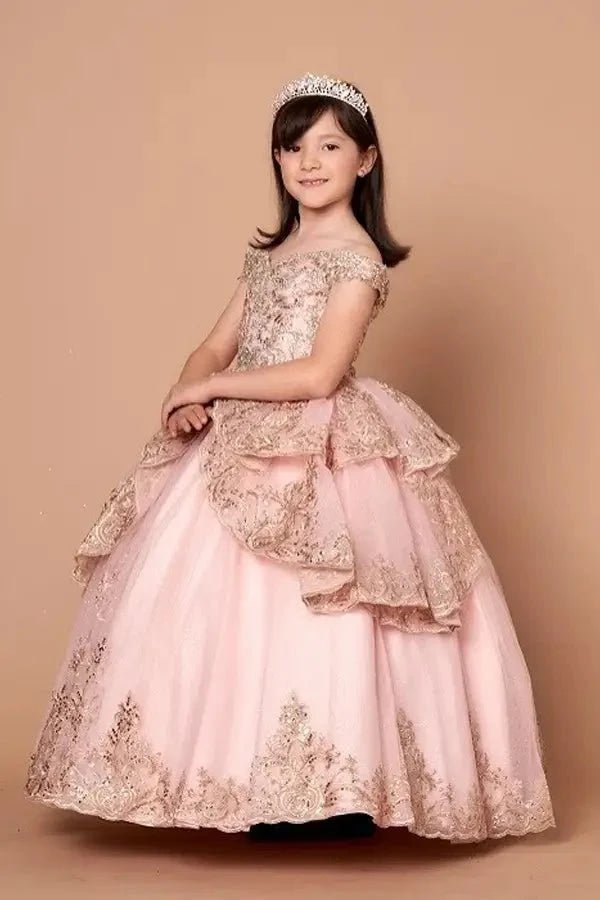 Side view of blush and gold mini quince dress with ornate embroidered layers, shimmering accents, and flowing full skirt.