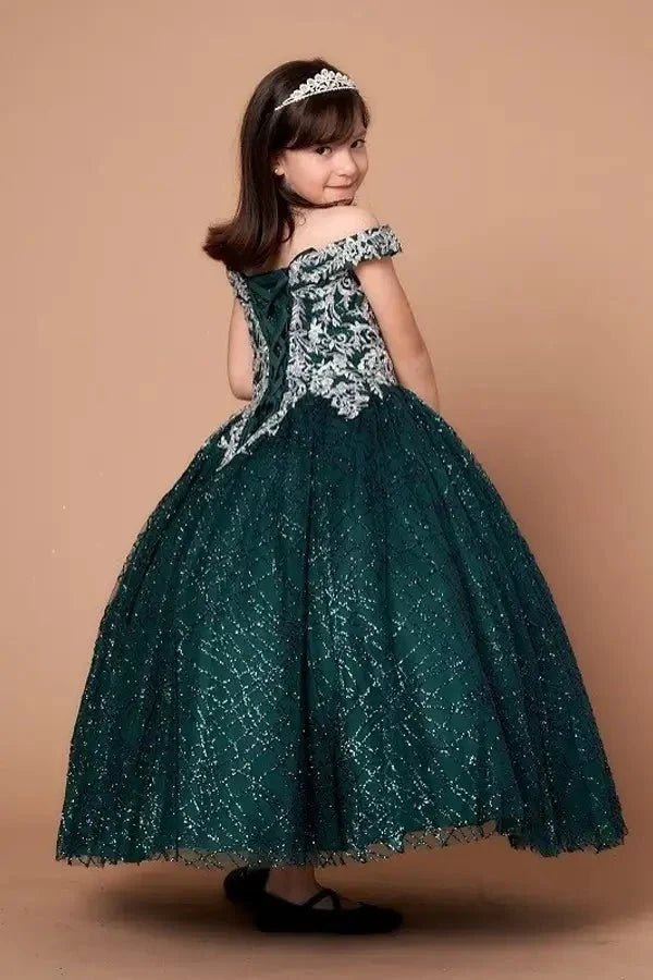 Side view of emerald green mini quince dress with dimensional 3D floral detail, shimmering glitter tulle highlights, and flowing layered skirt.