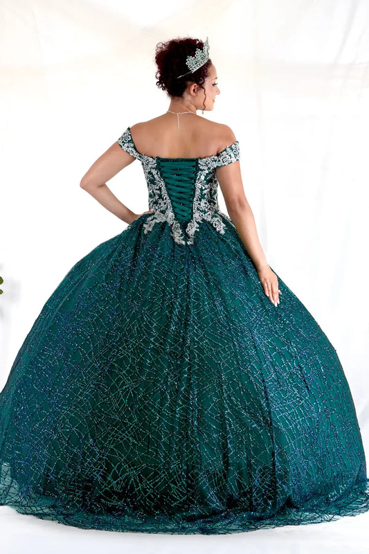 Back Close-Up of a woman wearing Back detail of emerald gown showing smooth finish glitter texture and refined construction