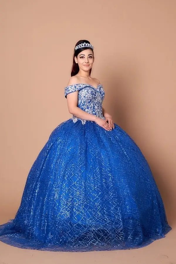 Front-Facing of a woman wearing Royal blue ball gown with sequin embellishments glitter tulle skirt and structured bodice