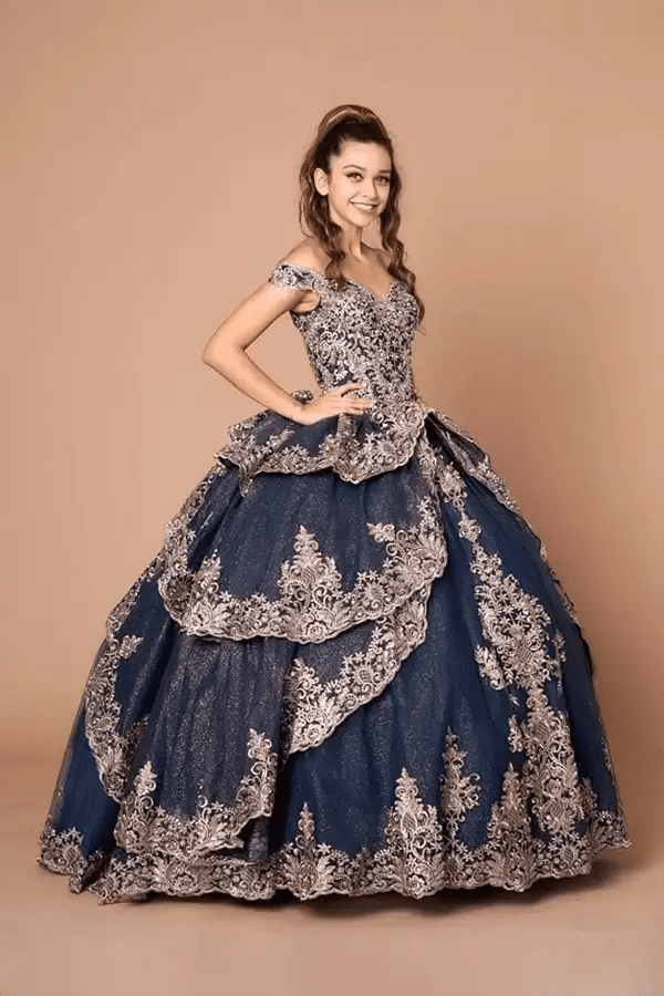 Front-Facing of a woman wearing Navy and gold quinceanera gown with off-shoulder sleeves intricate embroidery and layered skirt design