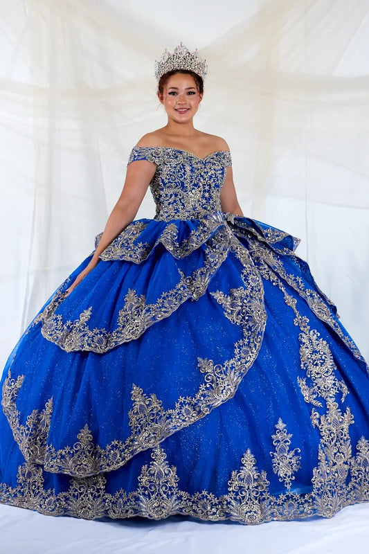 Front-Facing of a woman wearing Royal blue and gold quinceanera gown with off-shoulder sleeves intricate embroidery and layered skirt design
