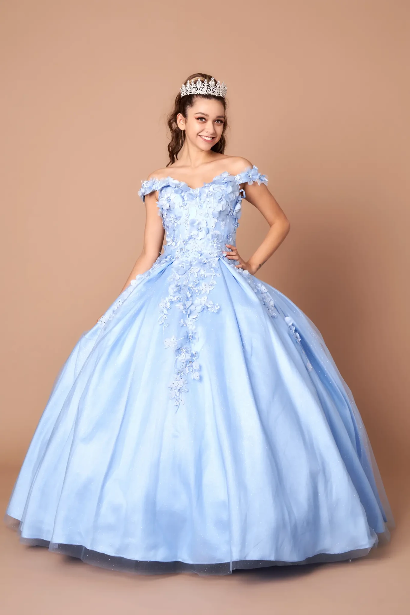 Front-Facing of a woman wearing Bahama blue ball gown with off-shoulder neckline intricate 3D floral appliqués and full flowing skirt