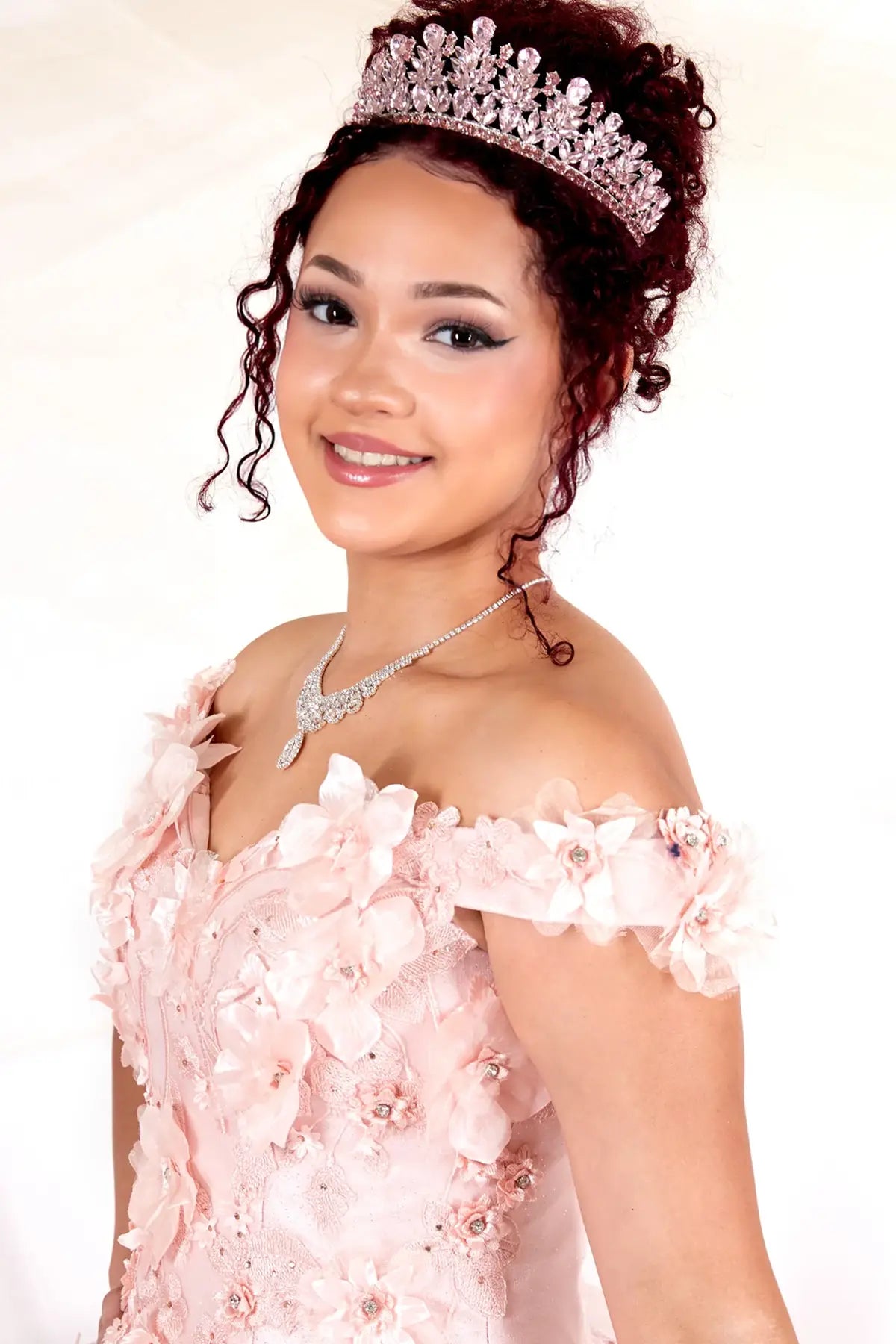 Front Close-Up of a woman wearing of blush bodice highlighting 3D floral appliqué off-shoulder neckline and detailed craftsmanship