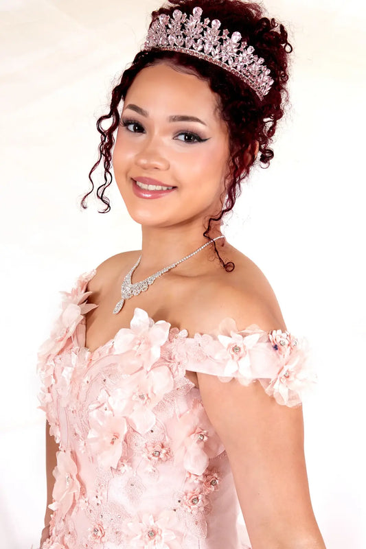 Front Close-Up of a woman wearing of blush bodice highlighting 3D floral appliqué off-shoulder neckline and detailed craftsmanship