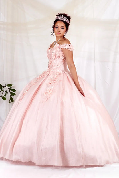 Side View of a woman wearing Soft pink gown with dimensional floral details sculpted bodice and flowing skirt shape