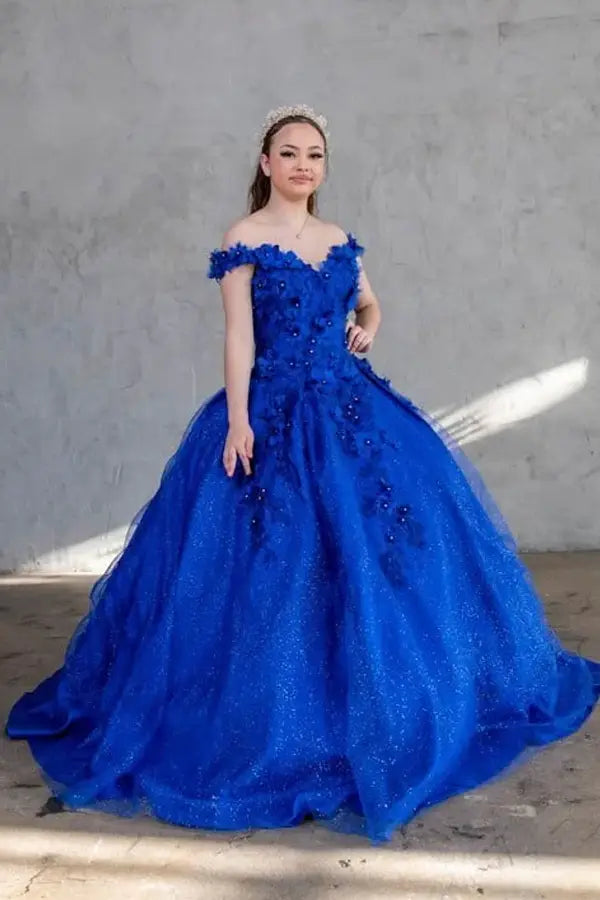 Front-Facing of a woman wearing Royal blue ball gown with off-shoulder neckline intricate 3D floral appliqués and full flowing skirt