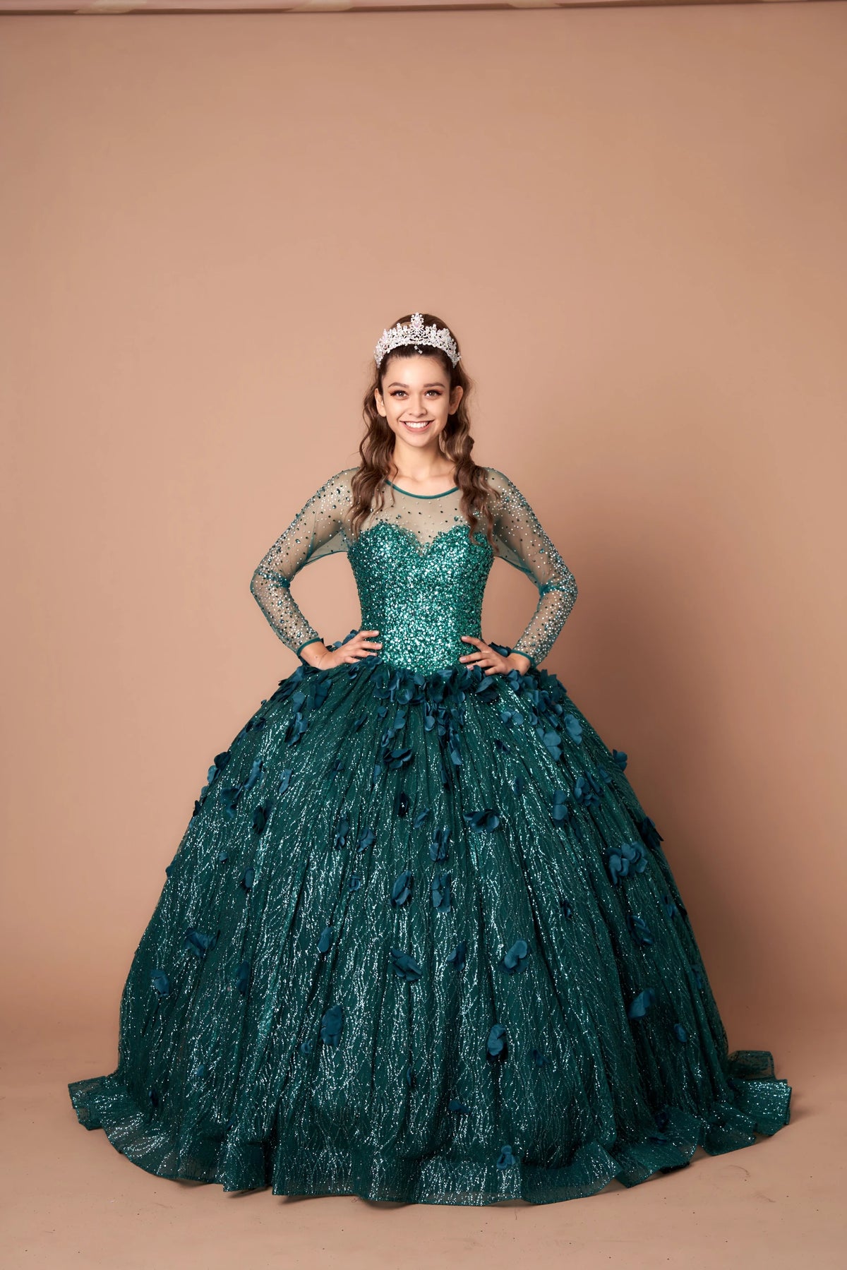 Sheer embellished long sleeves defines the Emerald Green quinceañera dress in this detailed view.