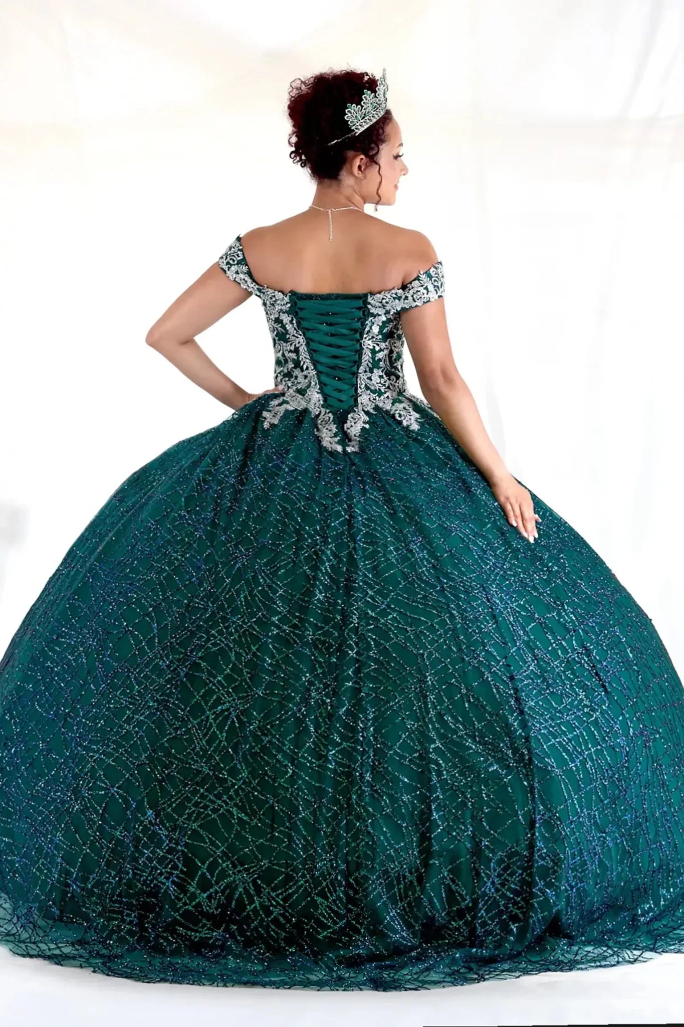Emerald green quinceañera ball gown with glitter sequins, sparkling bodice and layered tulle skirt