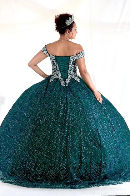 Close-up view reveals emerald green quinceañera ball gown with glitter sequins, sparkling bodice and layered tulle skirt.