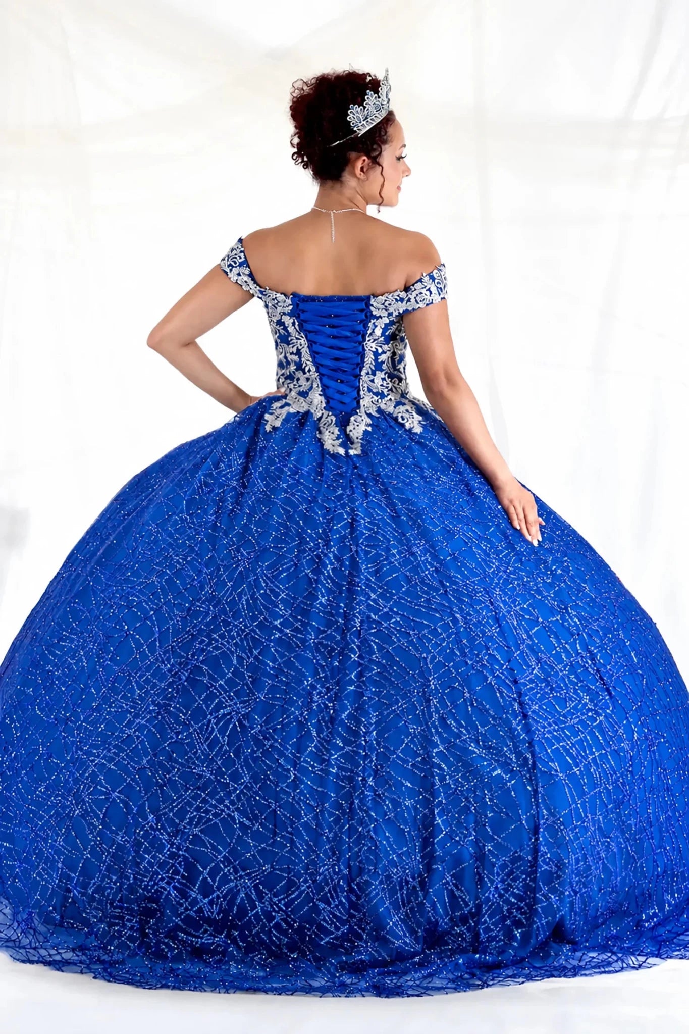 Royal blue quinceañera ball gown with glitter sequins, sparkling bodice and layered tulle skirt