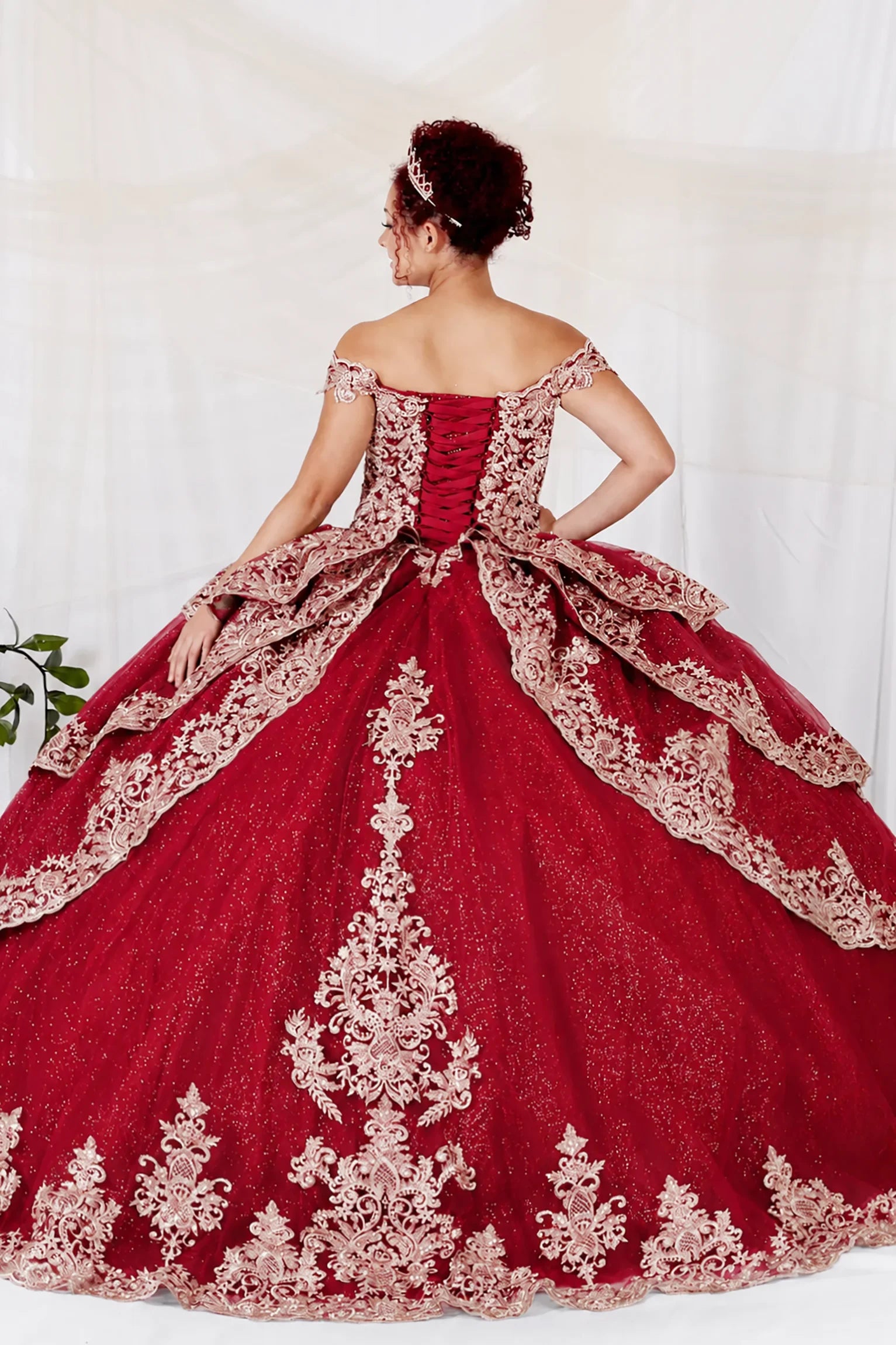 burgundy off-the-shoulder quince ball gown with intricate gold lace embroidery