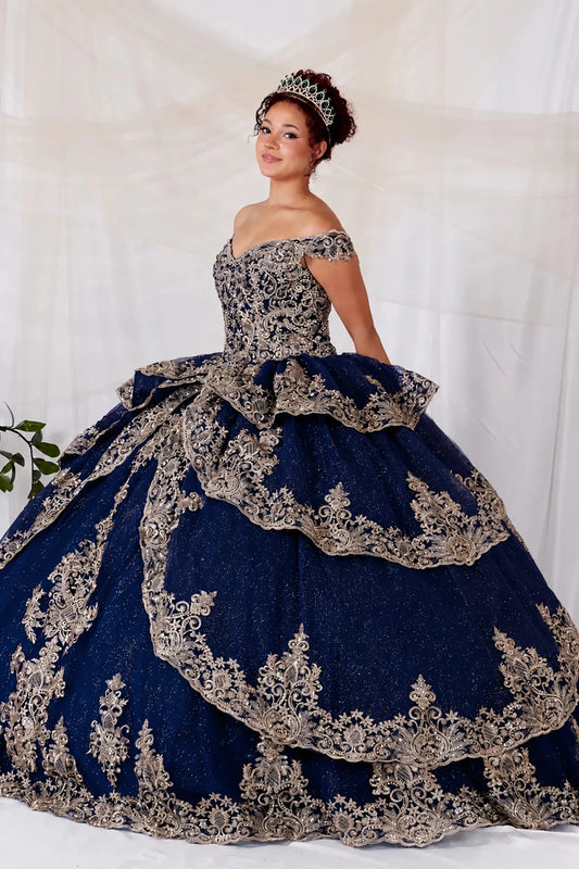 Bodice close-up highlights navy quinceañera ball gown with off‑shoulder neckline, gold embroidery and layered skirt.