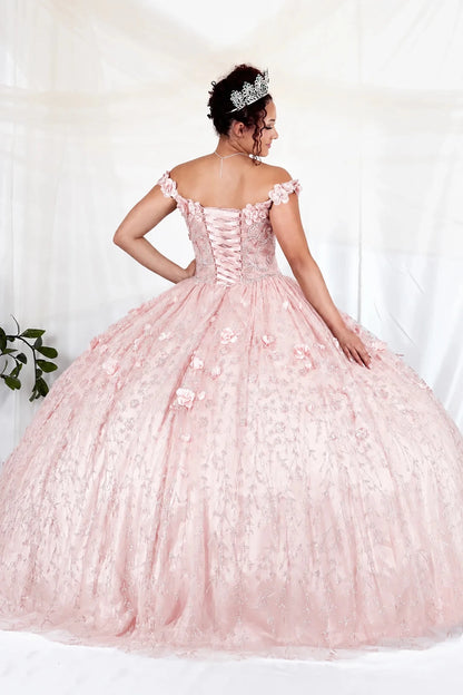 Close-up view reveals blush quinceañera ball gown with off‑shoulder neckline, delicate floral applique and flowing skirt.