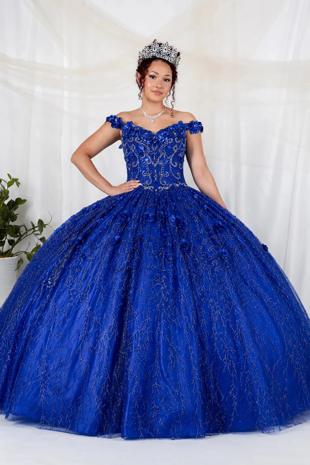 Royal blue quinceañera ball gown with off‑shoulder neckline, floral applique and flowing skirt