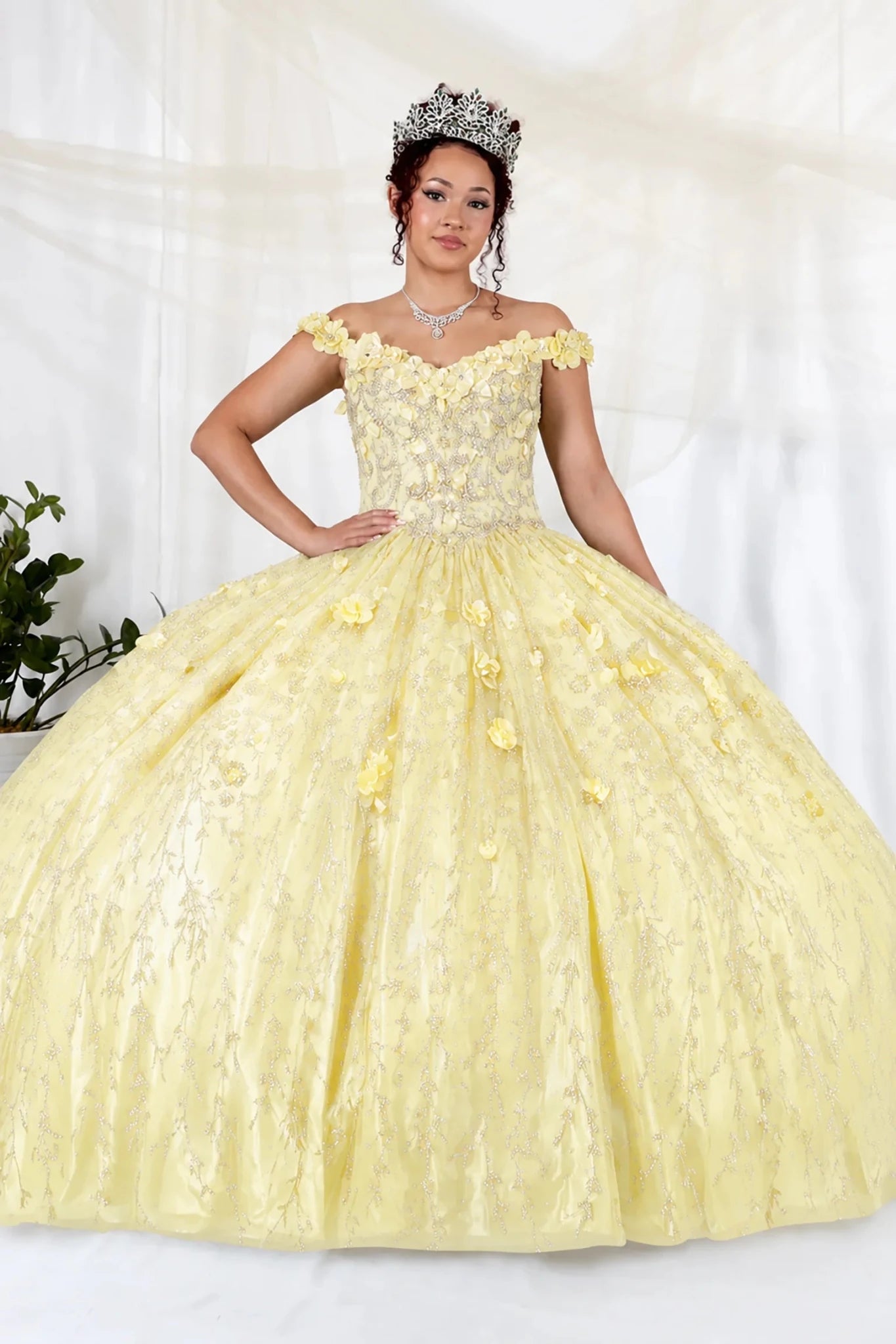 Yellow quinceañera ball gown with off‑shoulder neckline, floral applique and flowing skirt